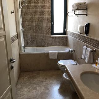 Bagno in marmo con vasca, lavabo e sanitari moderni